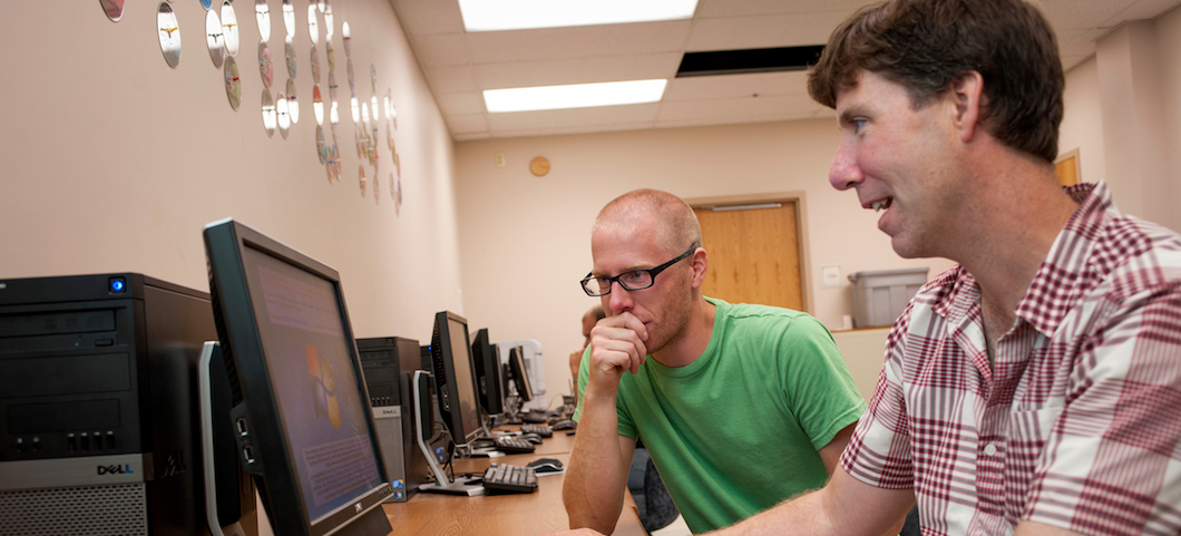 MSU faculty member working with another person at a computer